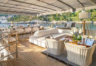 al fresco dining area and luxe seating area on the sundeck of luxury yacht Zulu