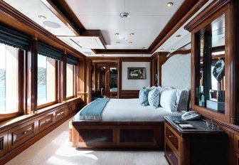 guest cabin on m/y titania, with bed overlooking views 