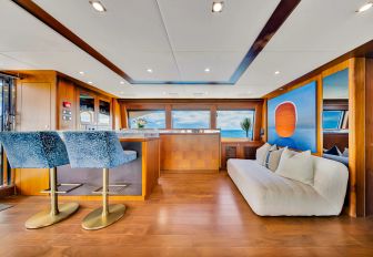 Charter yacht NATURAL 9 interiors with wet bar and sofa