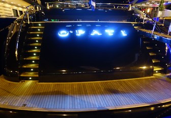 The lit-up stern of motor yacht O'PATI