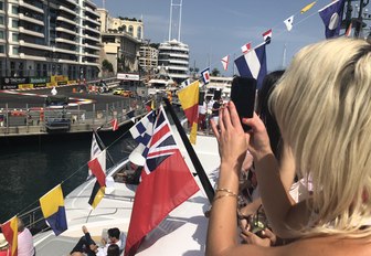 woman filming the track at the Monaco Grand Prix