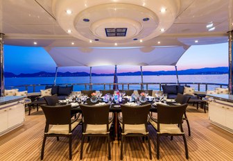 alfresco dining set up on the upper deck aft on board charter yacht Lucky Lady 