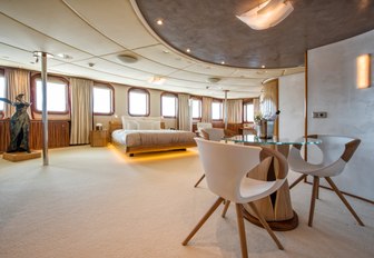 master cabin on charter yacht sherekhan, with seating area, statue and wide windows