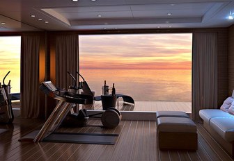 sun setting in background as seen from beach club on benetti charter yacht spectre, which features gym equipment