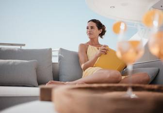 Female relaxing on sofa of explorer yacht SEAL