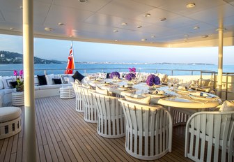 stylish alfresco dining setup on upper deck aft of superyacht MISCHIEF