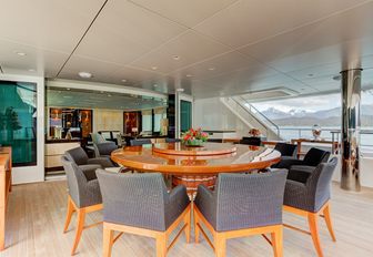 circular alfresco dining table on upper deck aft of charter yacht ‘Party Girl’ 