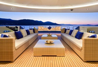 luxe seating area on the main deck aft of luxury yacht Mary-Jean II at sunset