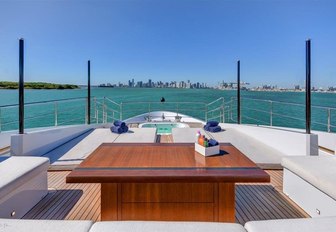 U-shaped seating and spa pool forward on the Portuguese bow aboard charter yacht Drew  