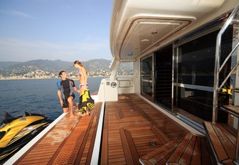 charter guests on the swim platform of charter yacht HANA 