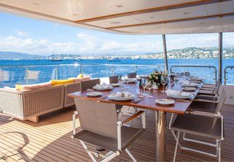 alfresco dining under the shade on the upper deck aft of motor yacht DYNAR