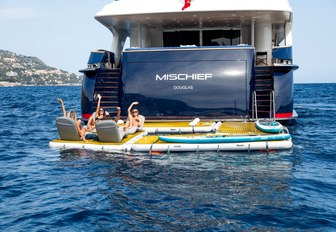 charter guests relax on floating pontoons aboard luxury yacht MISCHIEF