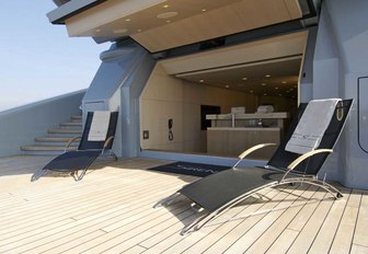 teak beach club with sun loungers aboard motor yacht SIREN