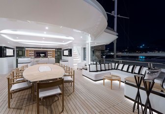 alfresco dining area adjoins a smaller seating area on the upper deck aft of charter yacht Liquid Sky 