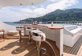 Charter yacht LOTUS exterior wet bar with white stools