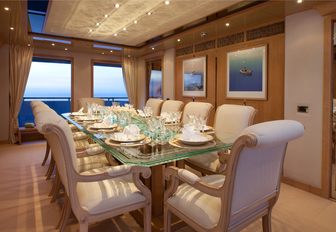 glass-topped dining table in dining salon aboard motor yacht SUNRISE 