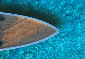 bow of a yacht in turquoise waters of the maldives