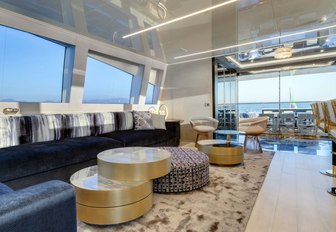 navy blue sofas in the light-filled main salon of superyacht Da Vinci 