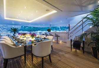 alfresco dining area is setup for dinner on the upper deck aft of charter yacht 11/11