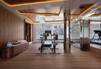 Cycling machines and a treadmill looking out to sea from the beach club of superyacht CLOUDBREAK