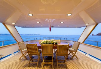 alfresco dining setup on aft deck of charter yacht LIBERTUS 