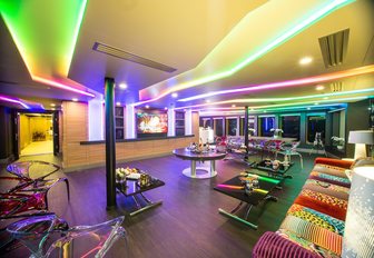Bright green and purple lights illuminating the interior of a superyacht