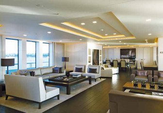 the sleek main salon of charter yacht siren with discreet lighting and modern furnishings provides her guests with ample space to enjoy themselves when not on her impressive collection of water toys