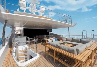 chic lounging area and alfresco dining option on upper deck aft of charter yacht Cheers 46 