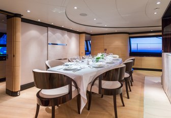 indoor dining area in the main salon aboard luxury yacht Q