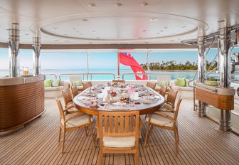 al fresco dining area on the upper deck aft of charter yacht CALYPSO