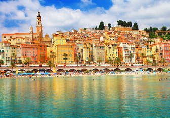 colourful houses reflected in calm aqua sea