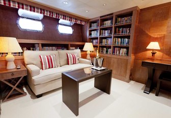 Office area on luxury yacht ELEMENT with bookcases and coffee table