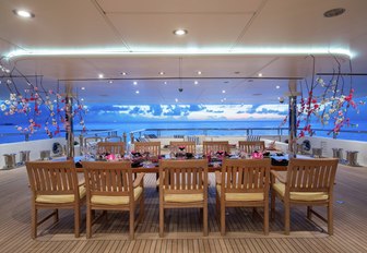 large al fresco dining area on board charter yacht TITANIA at twilight