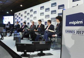 delegates participate in a conference at MIPIM, held in Cannes