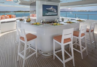 bar with stools and TV screen on the sundeck of luxury yacht Time For Us 