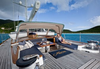 guest relaxes in the aft cockpit aboard charter yacht MARAE