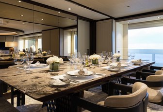 formal dining area flanked by huge windows on board luxury yacht LAURENTIA 