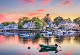 a dock in new england where everyone owns a motor yacht and spend their time on the water where guests on a  luxury yacht charter vacation destination