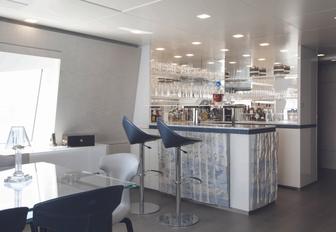 bar next to indoor dining table in skylounge aboard motor yacht ‘H