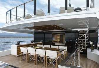 the upper aft deck of charter yacht EVA. 4EVA featuring alfresco dining table and plush dseating