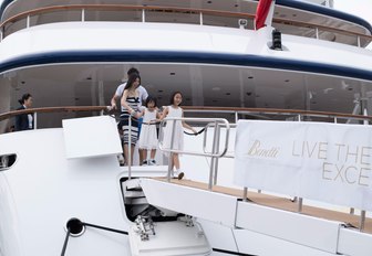 A family steps off a Benetti yacht at the Singapore Yacht Show