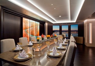 interior dining area with back-lit glass feature on board superyacht Mogambo