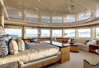 large bed and sofa in the master suite with 270-degree views aboard superyacht Lucky Lady 