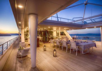 spacious alfresco dining area at sunset on board luxury yacht KATINA 