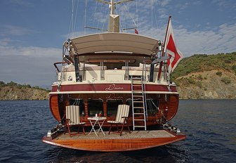 table and chairs set up on fold-down swim platform aboard charter yacht DAIMA