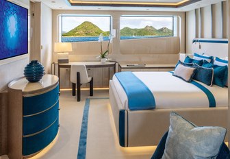 Super yacht charter AMOR A VIDA guest cabin with central berth and large windows