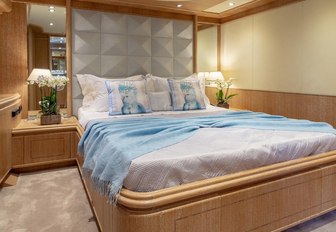 guest cabin with blue bedding in luxury charter yacht ANAMEL