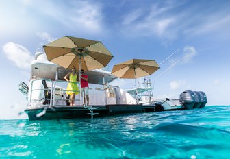 charter guests look out to sea from the swim platform of luxury yacht Remember When