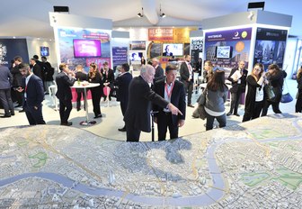 exhibitioners talk to attendees during MIPIM, held annually in Cannes