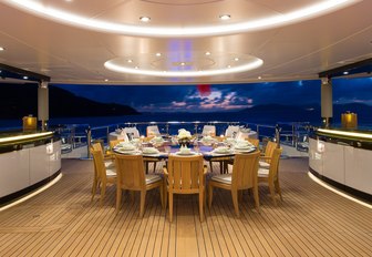 alfresco dining area at night on board superyacht KISMET